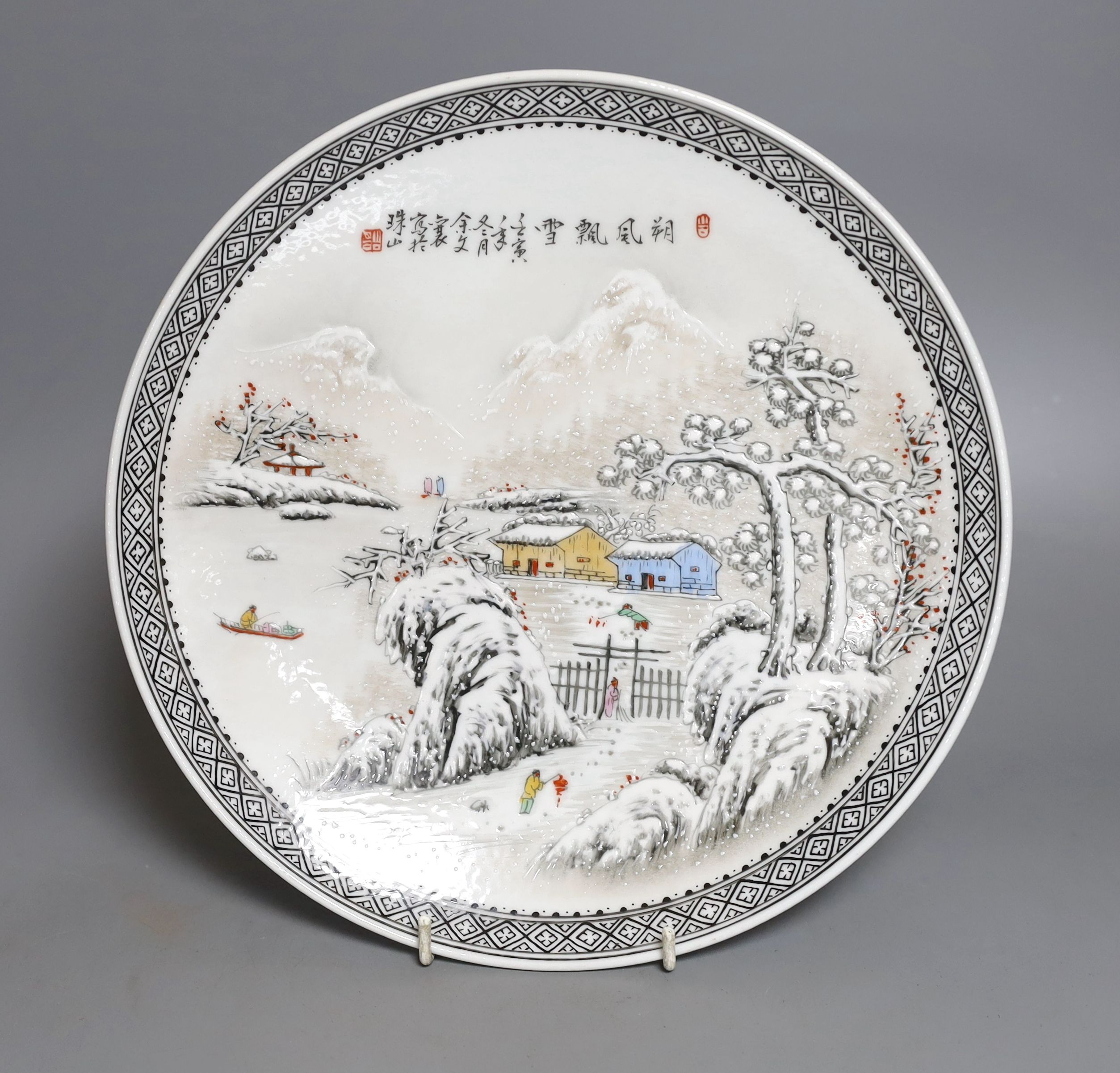 A Chinese famille rose plate depicting a winter scene - 27cm diameter